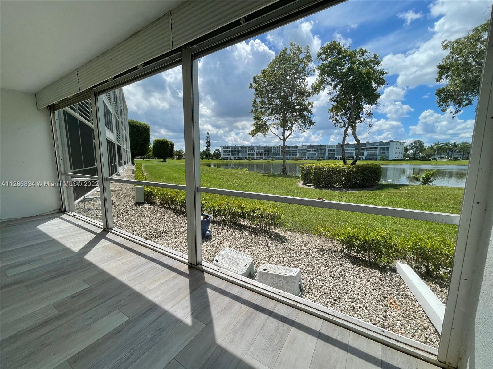 1084 Guildford East Boca Raton, FL 33434 - Photo 31 of 34 a view of a porch and a yard