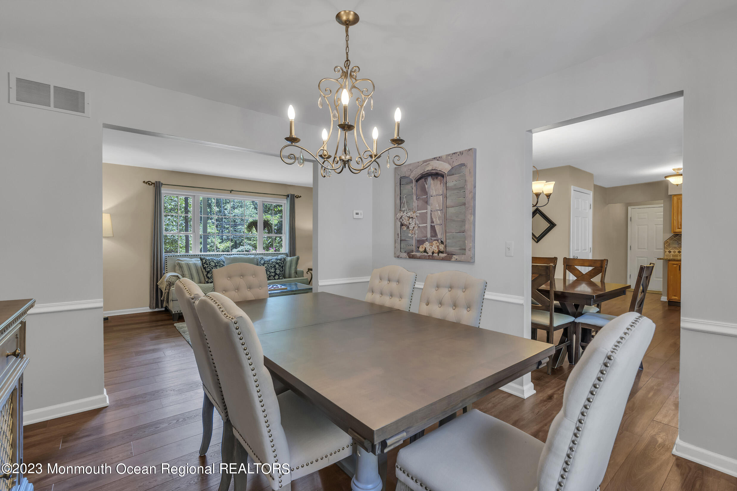 505 Leesville Road Jackson, NJ 08527 - Photo 20 of 58 a view of a dining room with furniture a chandelier and wooden floor