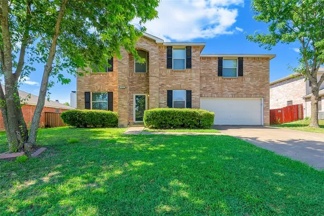 a front view of house with yard and trees