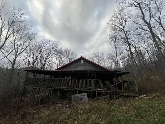 a front view of a house with yard and trees
