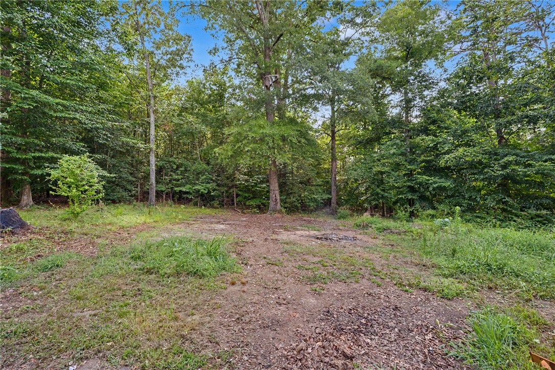 266 Ledford Farm Road Fair Play, SC 29643 - Photo 29 of 34 A spacious, partially cleared lot awaits your dream home, surrounded by lush, mature trees.