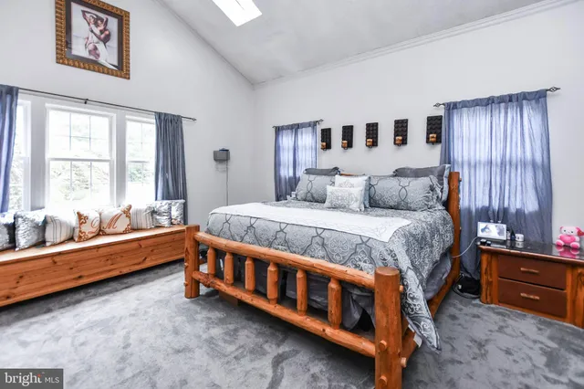 a large bed sitting in a room next to a window