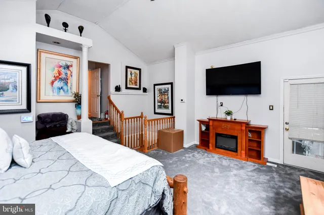 a bedroom with furniture and a flat screen tv