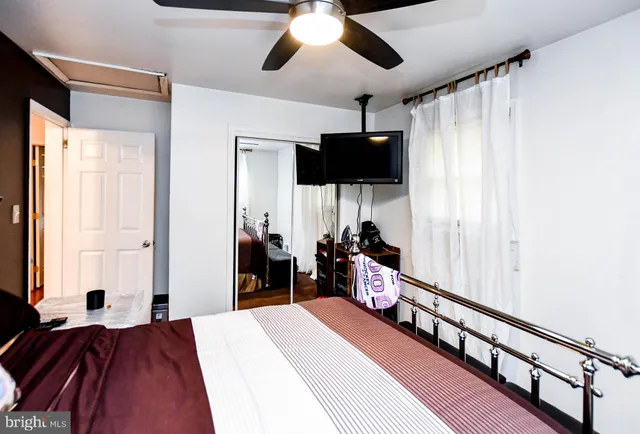 a bed room with a bed and a flat tv screen