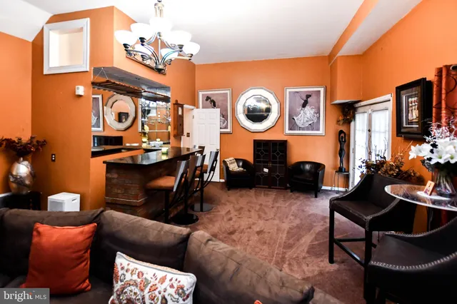 a living room filled with furniture and a large window
