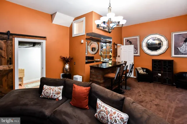 a living room with furniture a rug and a window