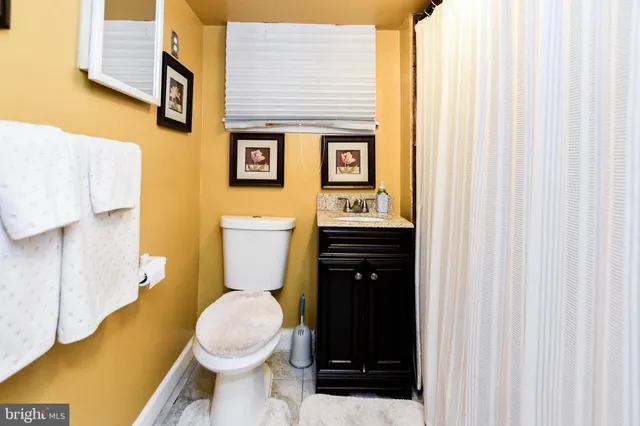 a white toilet sitting next to a bathroom sink