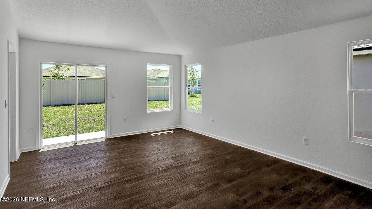 1 Divot Place Bunnell, FL 32110 - Photo 8 of 57 an empty room with wooden floor and windows