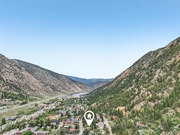 a view of a field with a mountain in the background