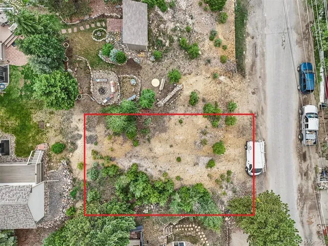an aerial view of a house with a yard and garden
