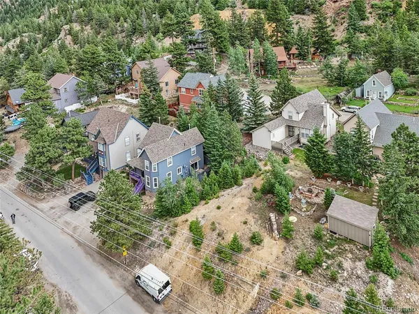 an aerial view of a house with a yard and garden