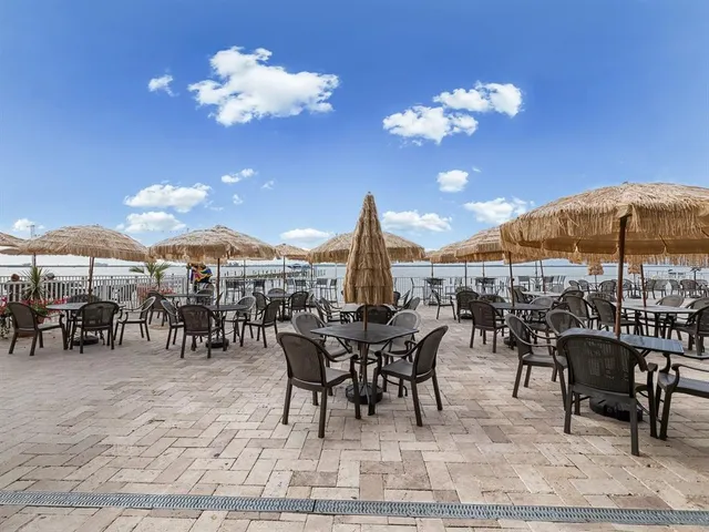 a living room with furniture a dining table and paintings on the wall