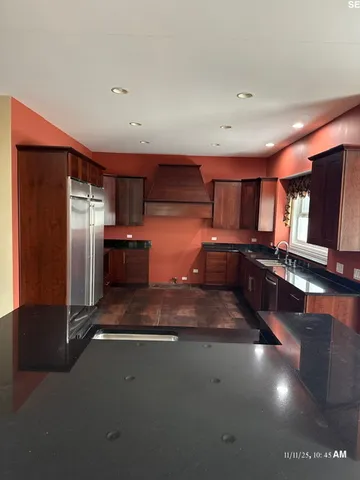 a kitchen with stainless steel appliances a refrigerator and a microwave