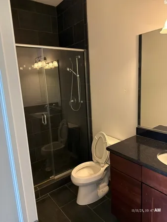 a bathroom with a toilet and a shower