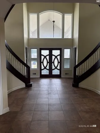 a view of an entryway with a floor to ceiling window and stairs