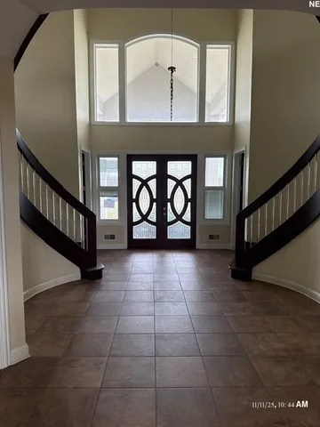 a view of an entryway with a floor to ceiling window and stairs