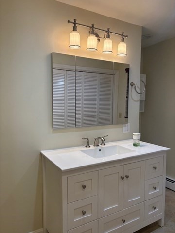 71 Old Amesbury Line Road Haverhill, MA 01830 - Photo 23 of 40 a bathroom with a sink double vanity and mirror
