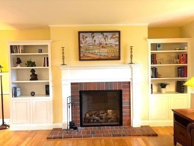 71 Old Amesbury Line Road Haverhill, MA 01830 - Photo 6 of 40 a living room with a fireplace and a wooden floor