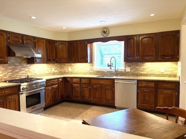 71 Old Amesbury Line Road Haverhill, MA 01830 - Photo 8 of 40 a kitchen with stainless steel appliances granite countertop a stove a sink and a microwave
