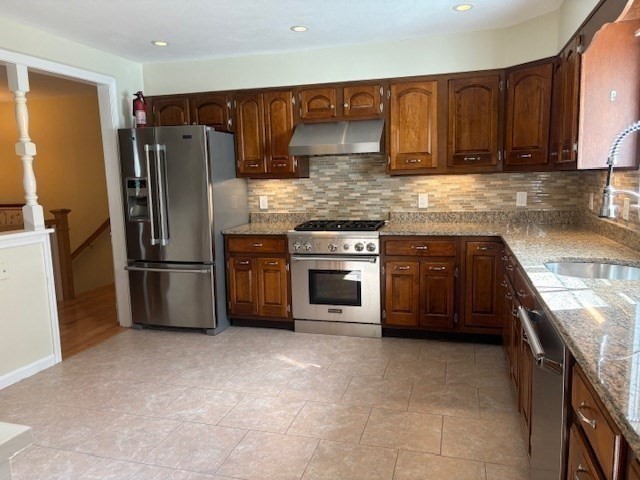 71 Old Amesbury Line Road Haverhill, MA 01830 - Photo 9 of 40 a kitchen with stainless steel appliances granite countertop a stove a sink and a refrigerator