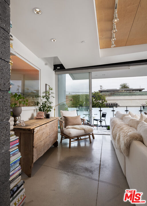 351 Sunset Avenue, Unit 5 Venice, CA 90291 - Photo 11 of 29 a living room with furniture and a floor to ceiling window