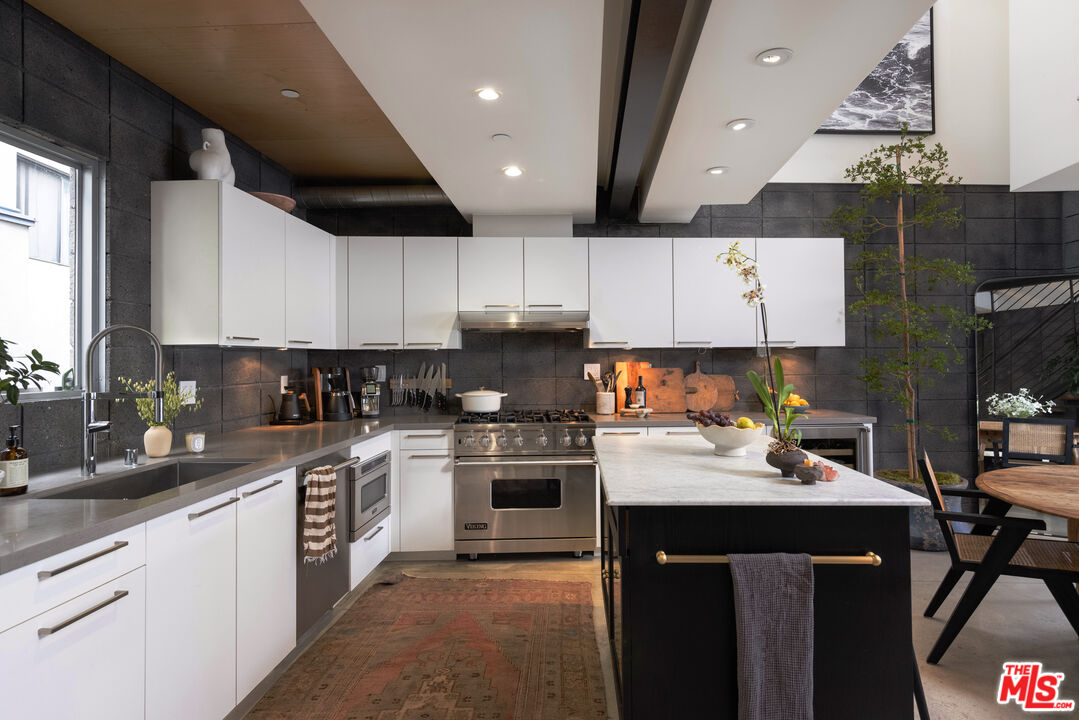 351 Sunset Avenue, Unit 5 Venice, CA 90291 - Photo 4 of 29 a kitchen with a sink a stove and cabinets