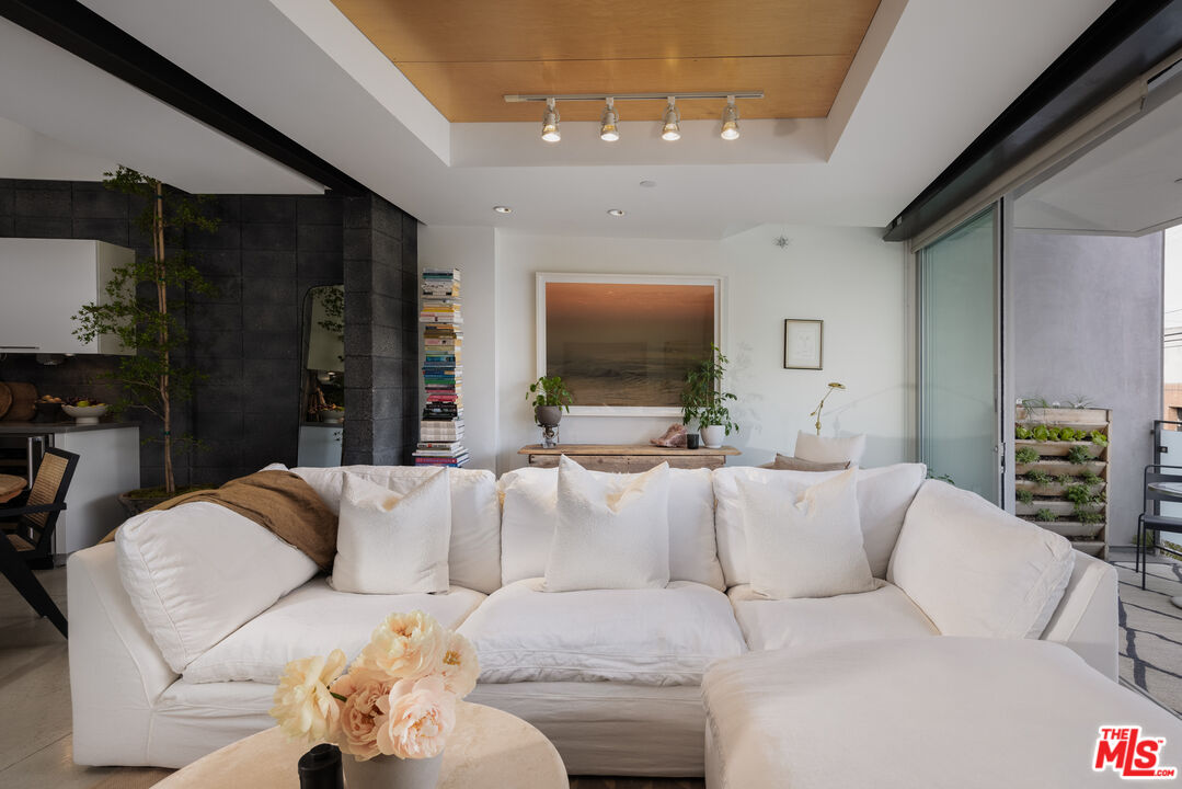 351 Sunset Avenue, Unit 5 Venice, CA 90291 - Photo 9 of 29 a living room with furniture and a flat screen tv