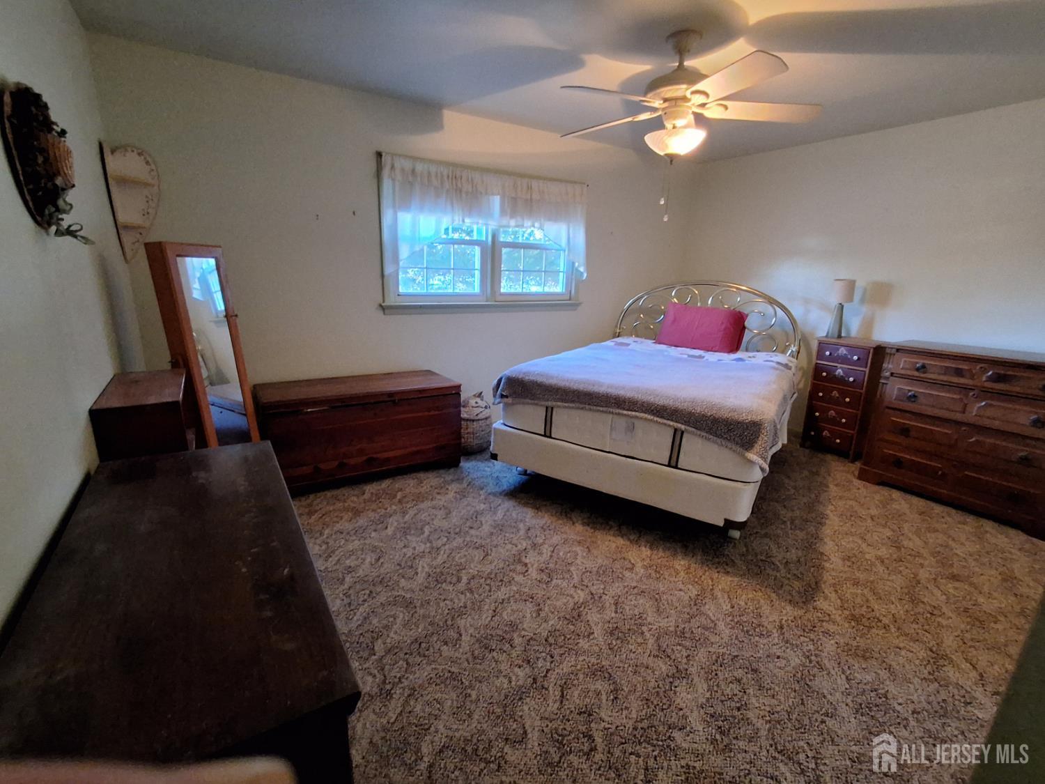 6 Nicholas Court Milltown, NJ 08850 - Photo 21 of 30 a spacious bedroom with a bed dresser and a window