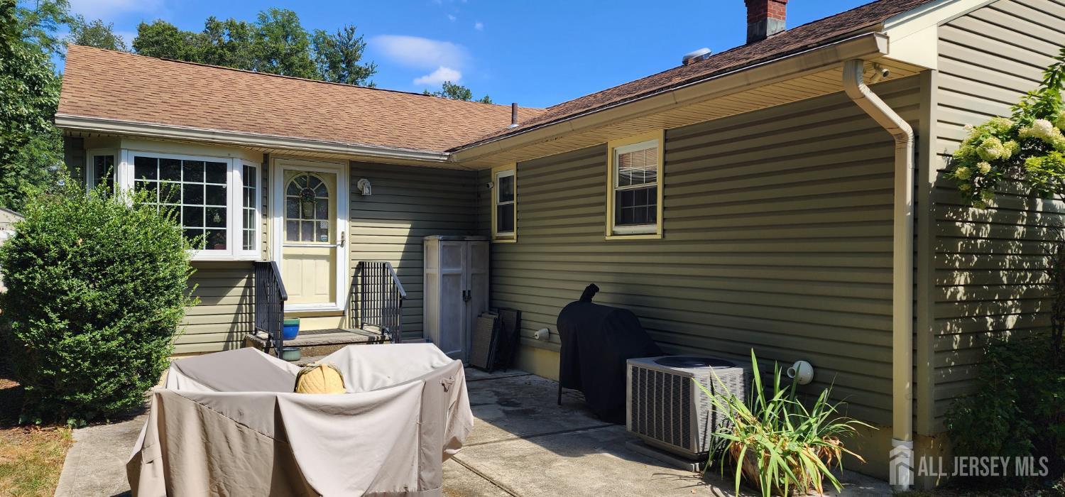 6 Nicholas Court Milltown, NJ 08850 - Photo 3 of 30 a view of a patio with table and chairs and potted plants
