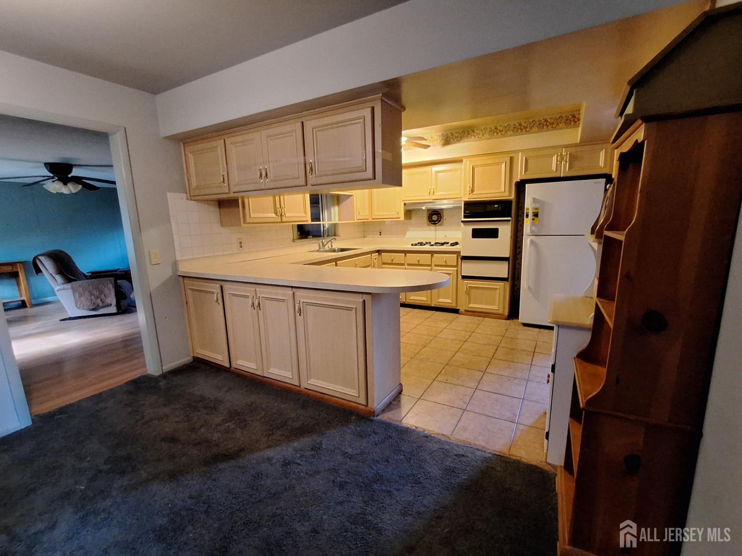 6 Nicholas Court Milltown, NJ 08850 - Photo 8 of 30 a kitchen with stainless steel appliances granite countertop a sink stove and refrigerator
