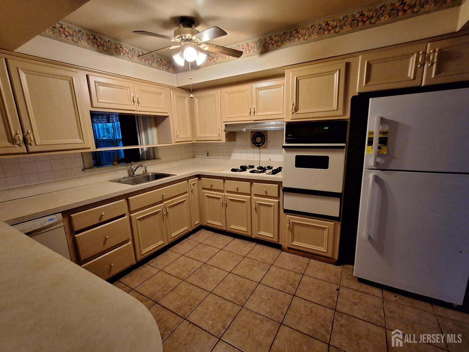 6 Nicholas Court Milltown, NJ 08850 - Photo 9 of 30 a kitchen with a sink appliances and cabinets