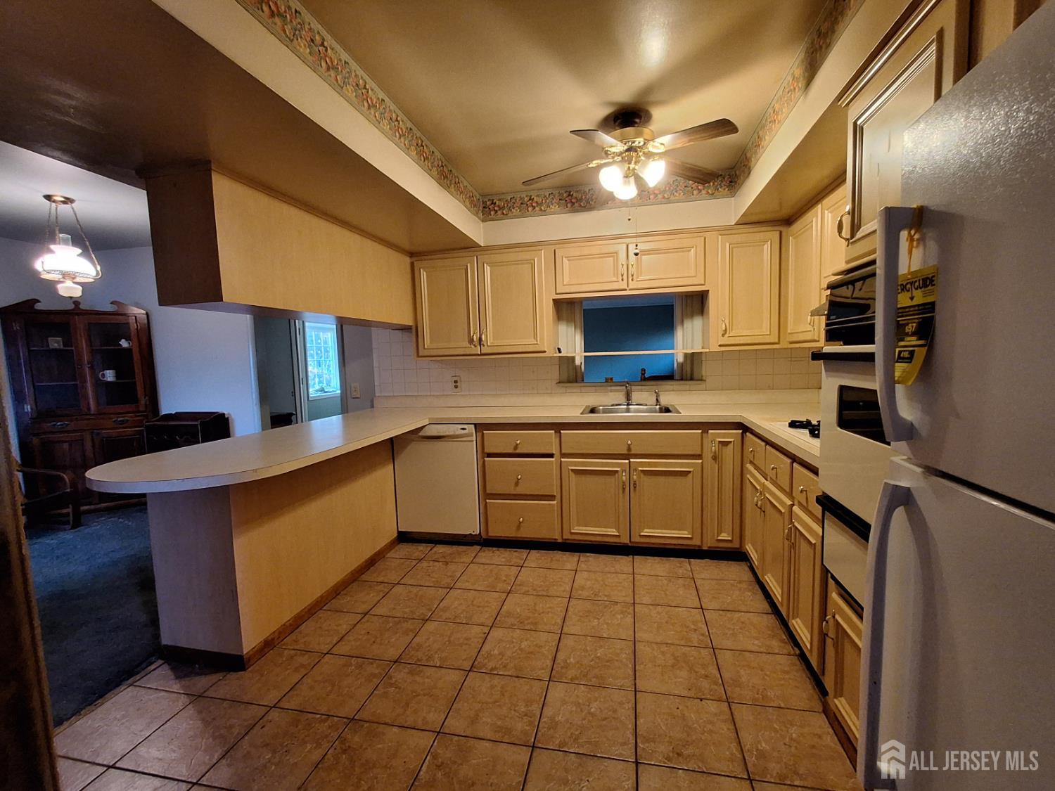 6 Nicholas Court Milltown, NJ 08850 - Photo 10 of 30 a kitchen with a sink window and stainless steel appliances