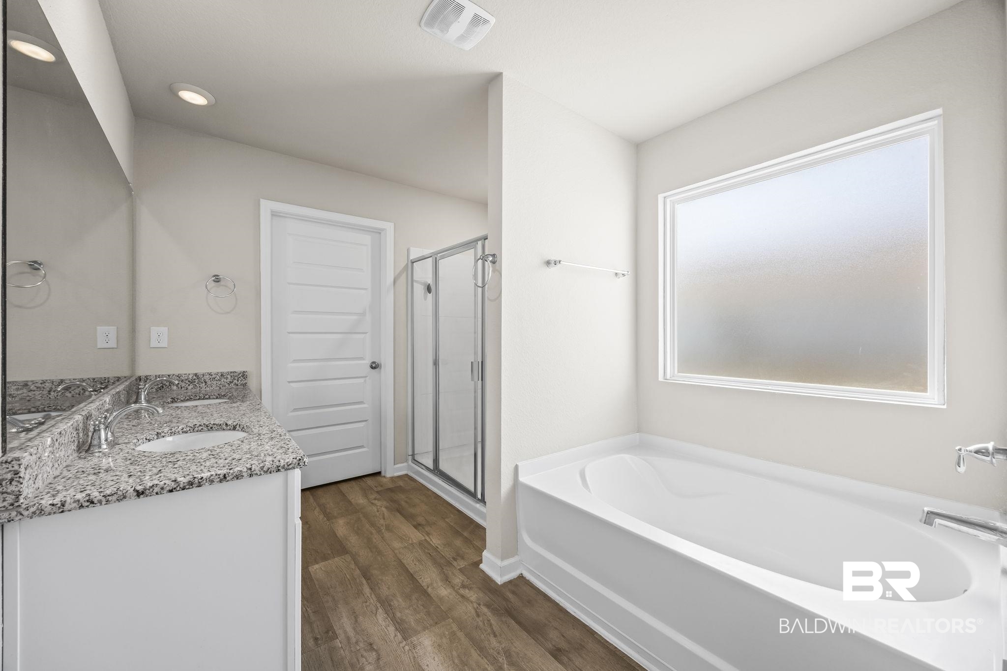 3090 Camino Real Loop Lillian, AL 36549 - Photo 26 of 29 Bathroom with a bath, double vanity, dark wood-type flooring, a shower stall, and recessed lighting