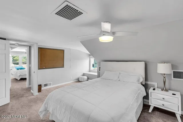 a bedroom with a bed and a lamp