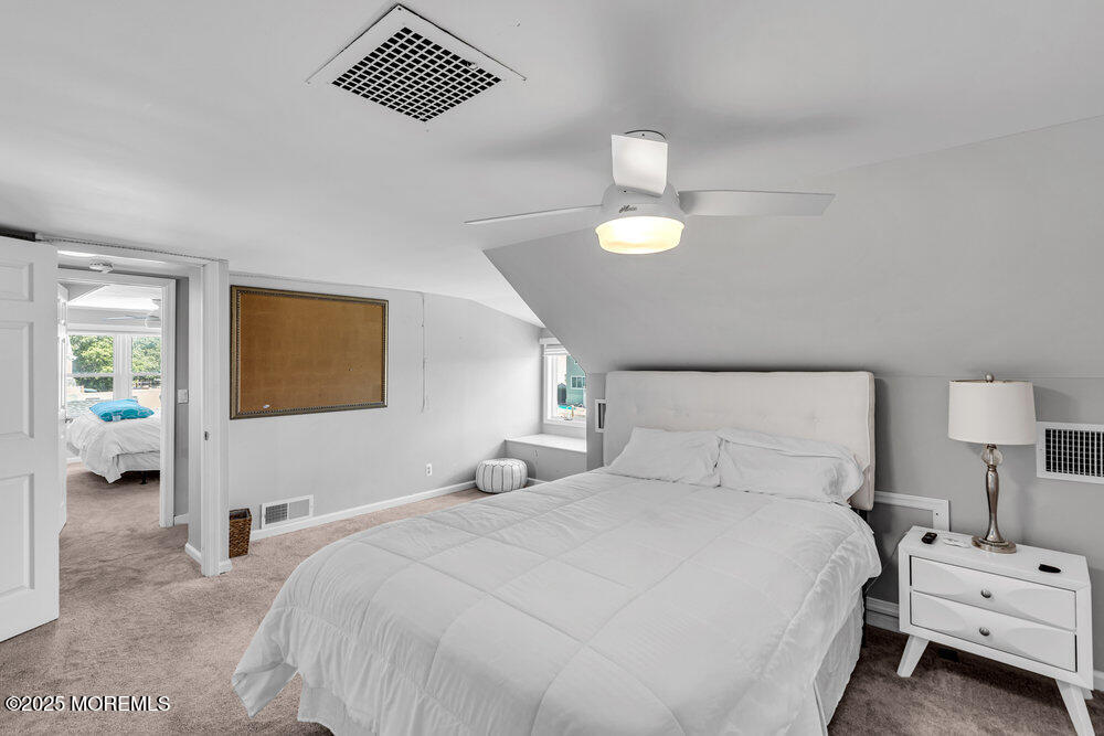 1648 Center Street Point Pleasant, NJ 08742 - Photo 12 of 26 a bedroom with a bed and a lamp