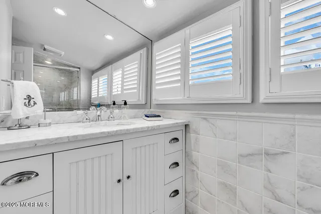 a bathroom with double sink and a mirror