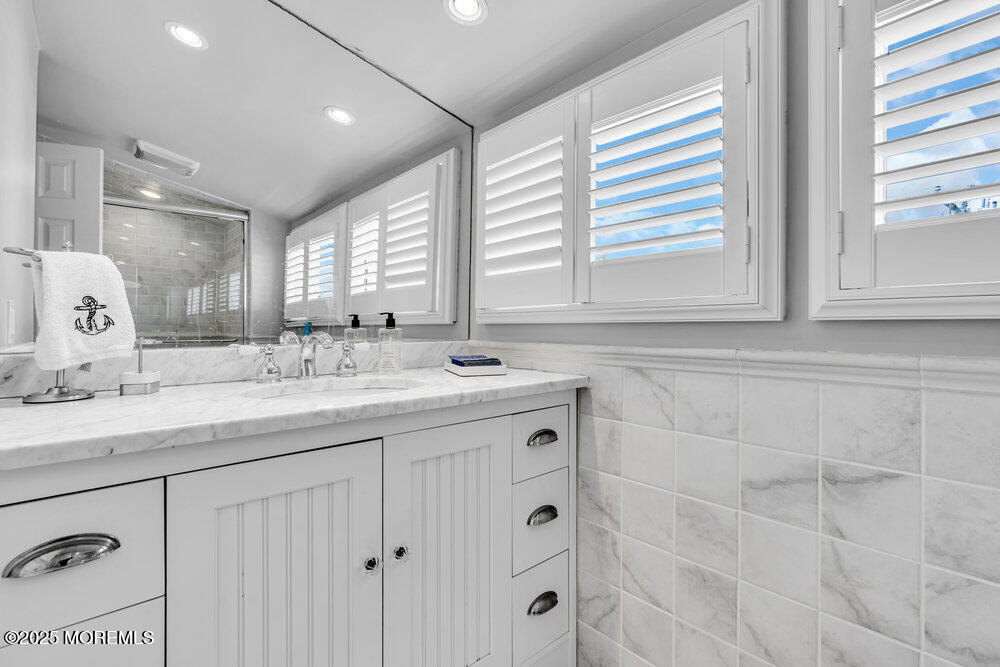 1648 Center Street Point Pleasant, NJ 08742 - Photo 14 of 26 a bathroom with double sink and a mirror