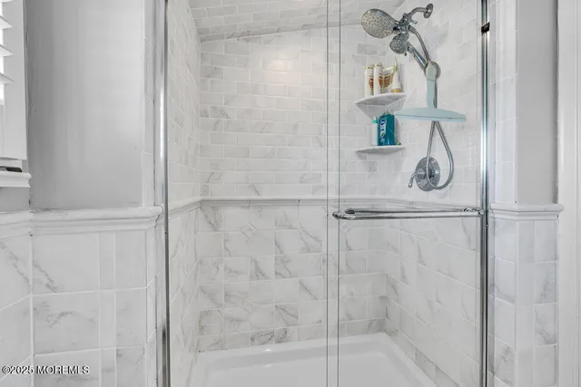 a bathroom with a glass shower door