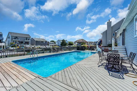 a view of swimming pool with outdoor seating and plants