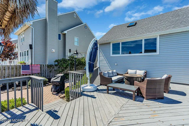 a view of a patio with couches table and chairs and potted plants