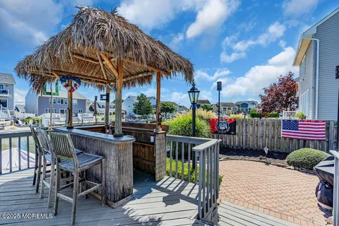 a view of a chairs and table in patio with a barbeque