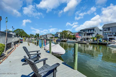 a view of swimming pool with outdoor seating and lake view