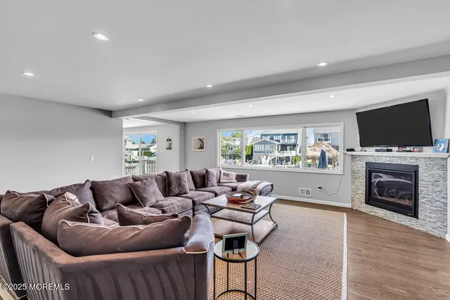 a living room with furniture a fireplace and a flat screen tv