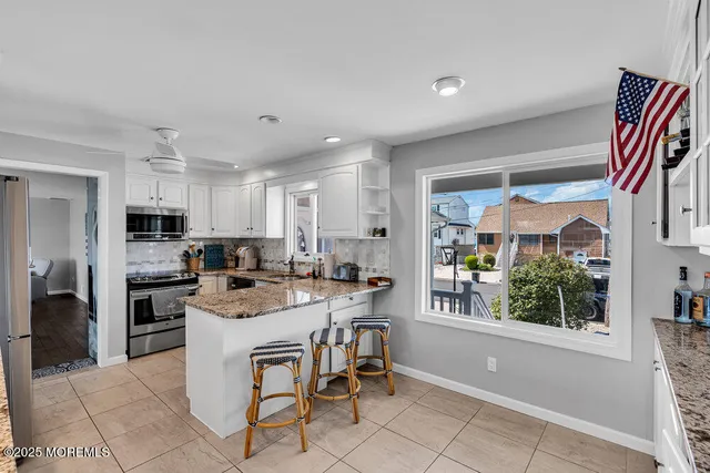 a kitchen with kitchen island a large counter top space appliances and cabinets