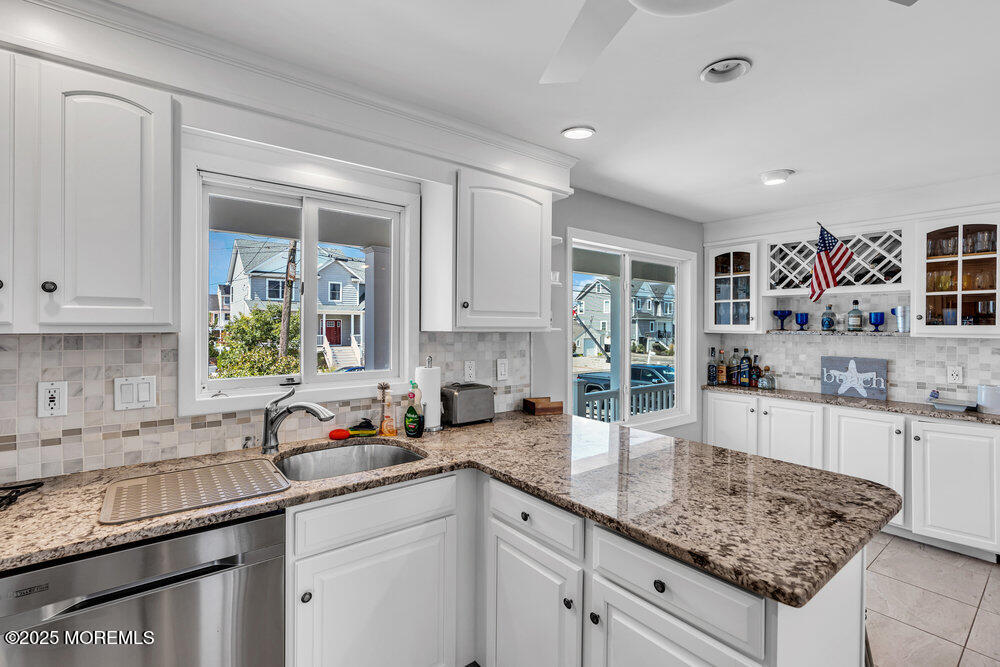 1648 Center Street Point Pleasant, NJ 08742 - Photo 7 of 26 a kitchen with granite countertop a sink a stove and cabinets