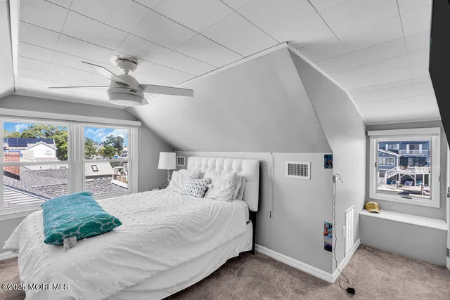 a bedroom with a large bed and a window