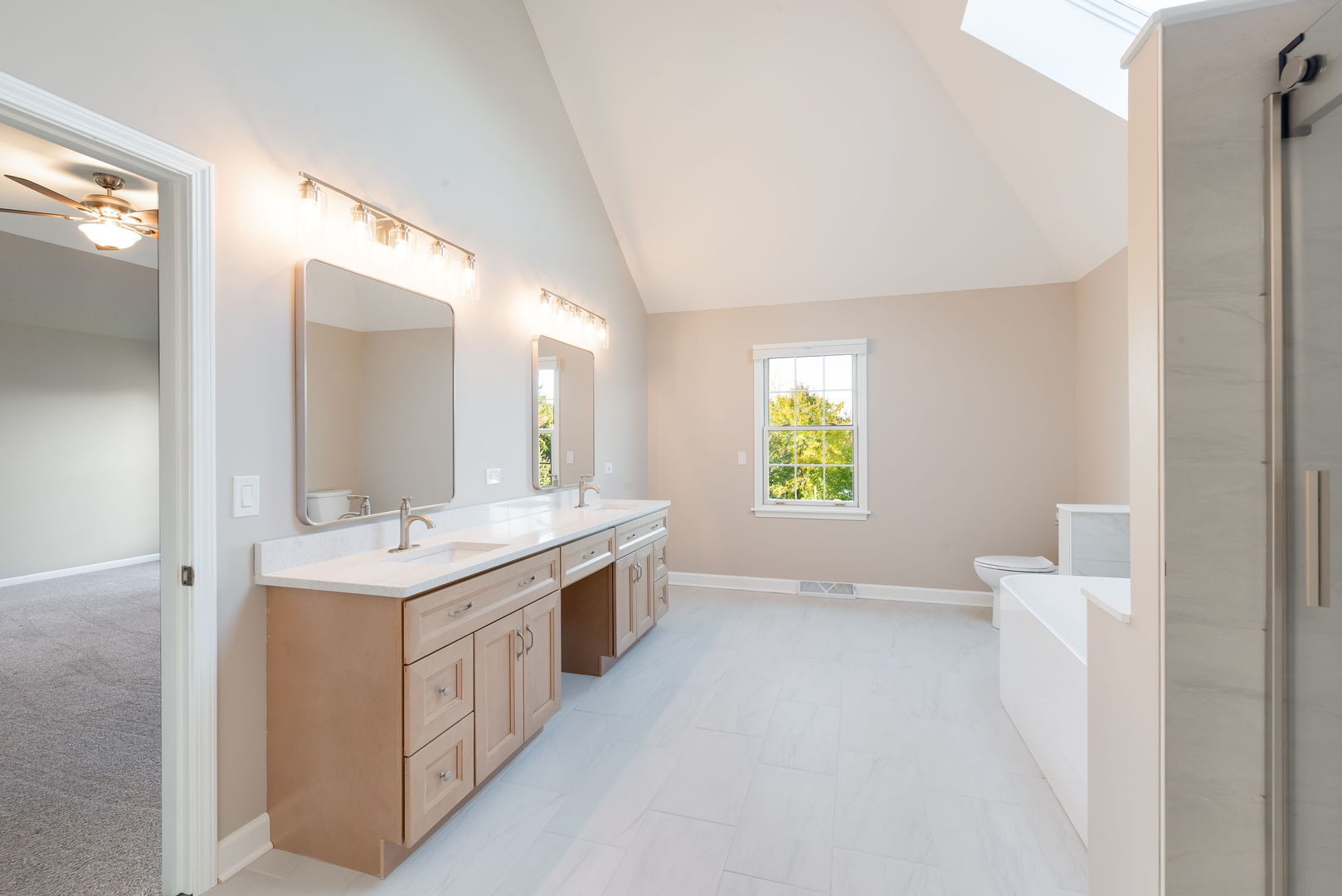 2147 Fargo Boulevard Geneva, IL 60134 - Photo 13 of 27 a bathroom with a double vanity sink a toilet and a mirror