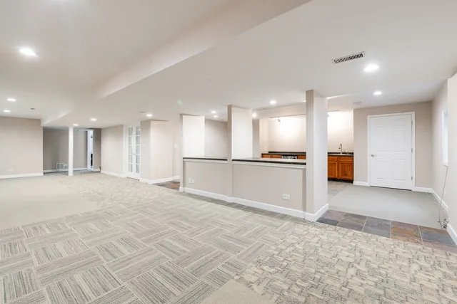 a view of a kitchen with kitchen island wooden floor and stainless steel appliances