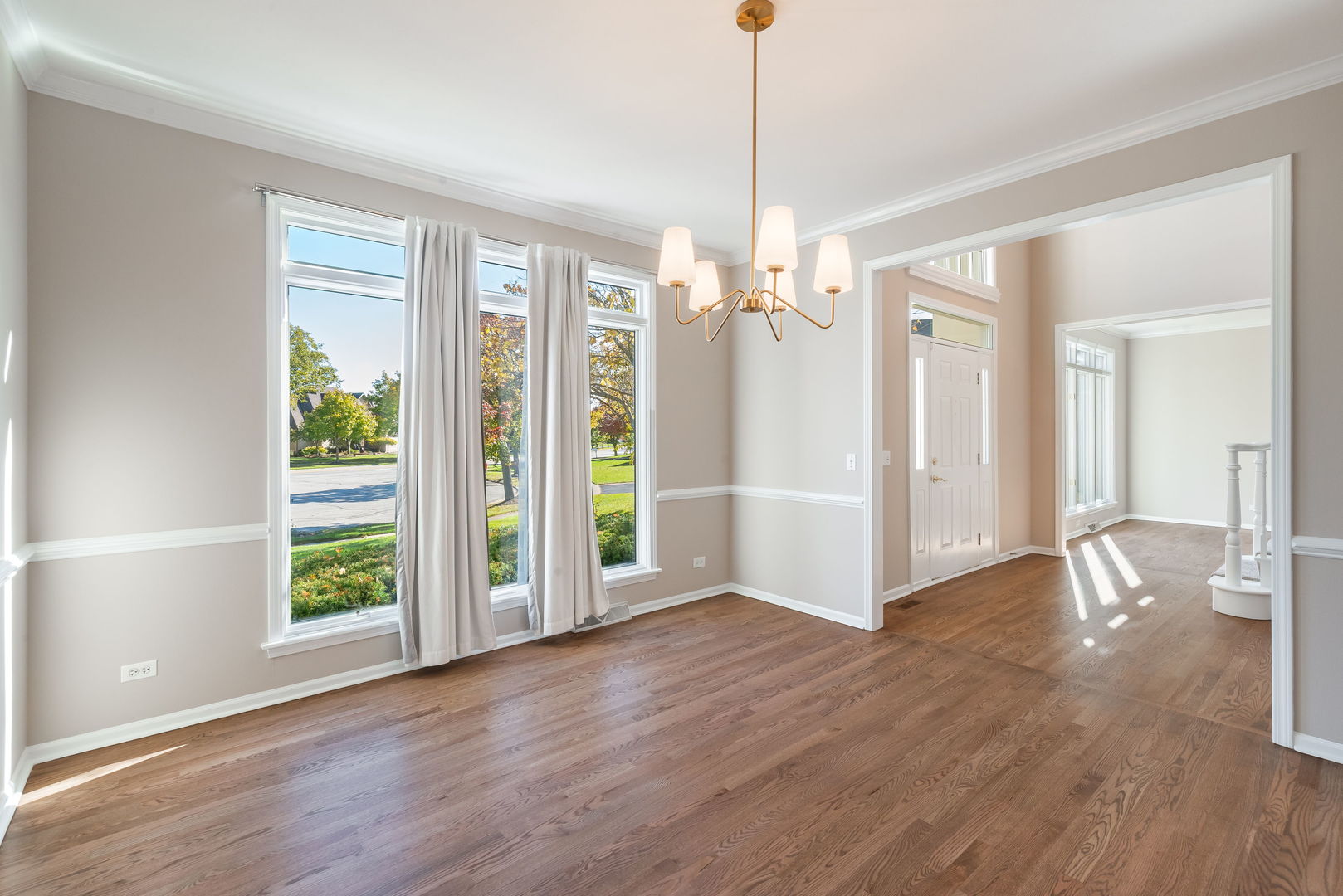 2147 Fargo Boulevard Geneva, IL 60134 - Photo 3 of 27 a view of an empty room with wooden floor fridge and a chandelier