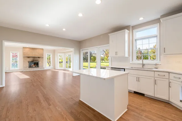 a view of kitchen with wooden floor and electronic appliances